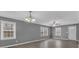Spacious, sunlit living room featuring luxury vinyl flooring, neutral gray walls, and large windows at 80 Holder St, Temple, GA 30179