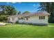 Cozy single-story home featuring a large front yard with a well-maintained lawn and green awning at 3551 Lavista Rd, Decatur, GA 30033