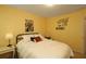 Bedroom with yellow walls showcasing a full bed, decorative pillows, and charming wall decor at 5433 Cascade Sw Rdg, Atlanta, GA 30336