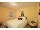 Bedroom with yellow walls featuring a full bed, decorative pillows, and a bright, cheerful ambiance at 5433 Cascade Sw Rdg, Atlanta, GA 30336