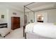 Spacious primary bedroom showcasing a four-poster bed, walk-in closet, and an en suite bathroom at 5433 Cascade Sw Rdg, Atlanta, GA 30336