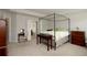 Primary bedroom showcasing a four-poster bed with an en suite bathroom and a vanity at 5433 Cascade Sw Rdg, Atlanta, GA 30336