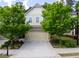 Charming townhouse showcasing a 2-car garage, lush landscaping, and a well-maintained lawn at 5433 Cascade Sw Rdg, Atlanta, GA 30336