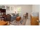 Cozy living room featuring a comfortable blue sofa, stylish area rug, and bright natural light at 5433 Cascade Sw Rdg, Atlanta, GA 30336