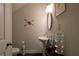 Elegant powder room with pedestal sink, decorative mirror, and stylish decor at 5433 Cascade Sw Rdg, Atlanta, GA 30336