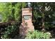 Elegant brick sign marking the entrance to Cascade Place, surrounded by vibrant greenery and flowers at 5433 Cascade Sw Rdg, Atlanta, GA 30336
