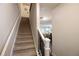 Carpeted staircase with white railings offering a glimpse into the dining area at 5433 Cascade Sw Rdg, Atlanta, GA 30336