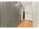 Hallway with wood floors, gray trim, and gray closet doors at 747 Ralph Mcgill Ne Blvd # 326, Atlanta, GA 30312