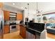Modern kitchen featuring stainless steel appliances, wooden cabinets, black countertops, and a view to the living room at 747 Ralph Mcgill Ne Blvd # 326, Atlanta, GA 30312
