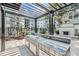 A shaded outdoor kitchen features a built-in grill, counter space, sink and a cozy fireplace at 747 Ralph Mcgill Ne Blvd # 326, Atlanta, GA 30312