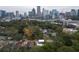 Scenic aerial view of residential homes and the Atlanta skyline with lush trees providing privacy at 1186A Francis Nw St, Atlanta, GA 30318