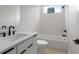Elegant bathroom featuring white marble countertops, dark fixtures, and a soaking tub beneath a window at 1186A Francis Nw St, Atlanta, GA 30318