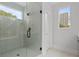 Modern bathroom featuring glass-enclosed shower, white marble tile, and a window showcasing the outdoor view at 1186A Francis Nw St, Atlanta, GA 30318
