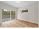 Sunlit bedroom with hardwood floors, sliding glass doors to deck, and a cozy window with nature views at 1186A Francis Nw St, Atlanta, GA 30318