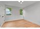 Inviting bedroom with hardwood flooring, neutral walls, modern lighting, and bright windows with wooded views at 1186A Francis Nw St, Atlanta, GA 30318