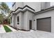 Modern home exterior featuring gray siding, a dark garage door, and neat landscaping, enhancing curb appeal at 1186A Francis Nw St, Atlanta, GA 30318