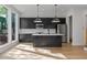 Contemporary kitchen with black cabinets, center island, and stainless steel appliances at 1186A Francis Nw St, Atlanta, GA 30318