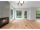 Elegant living room with a modern fireplace, hardwood floors, and large windows at 1186A Francis Nw St, Atlanta, GA 30318