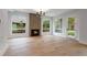 Spacious living room with a modern fireplace, large windows, and hardwood floors at 1186A Francis Nw St, Atlanta, GA 30318