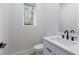 A stylish powder room with a modern vanity, white countertop, black faucet, and a framed mirror at 1186A Francis Nw St, Atlanta, GA 30318