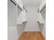 Spacious walk-in closet with custom white shelving and sleek black rods, perfect for organized storage at 1186A Francis Nw St, Atlanta, GA 30318