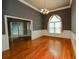 Open-concept dining room with hardwood floors, decorative trim, chandelier and arched doorways to other rooms at 1270 Tribble Walk Ct, Lawrenceville, GA 30045