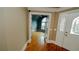 Open entryway featuring hardwood floors, a transom window, and glass-paneled doors that offer bright, natural light at 1270 Tribble Walk Ct, Lawrenceville, GA 30045