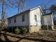 Rear home exterior featuring an entrance and multiple windows at 2305 Phillips Rd, Lithonia, GA 30058