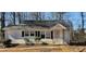 Modest single story home featuring a compact front porch, classic windows, and a mature yard at 2305 Phillips Rd, Lithonia, GA 30058