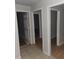 Hallway with tile flooring and various open doors at 2305 Phillips Rd, Lithonia, GA 30058