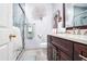 Stylish bathroom featuring a dark wood vanity, glass shower, and modern fixtures at 5306 Brooke Ridge Dr, Atlanta, GA 30338