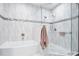 Modern bathroom with a tub, walk-in shower with glass, and neutral-toned tiles at 5306 Brooke Ridge Dr, Atlanta, GA 30338