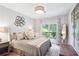 Serene bedroom with a plush bed, balcony access, and decorative wall art at 5306 Brooke Ridge Dr, Atlanta, GA 30338