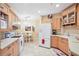 Well-lit kitchen with light wood cabinetry, stainless steel appliances, and adjacent dining area at 5306 Brooke Ridge Dr, Atlanta, GA 30338