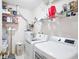 Functional laundry room with modern washer and dryer, and ample shelving for storage at 5306 Brooke Ridge Dr, Atlanta, GA 30338