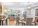 Elegant living and dining area with hardwood floors, fireplace, and stylish chandelier at 5306 Brooke Ridge Dr, Atlanta, GA 30338