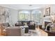 Cozy living room featuring a comfortable sofa, armchairs, fireplace, and large windows at 5306 Brooke Ridge Dr, Atlanta, GA 30338