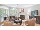 Inviting living room with a comfortable seating arrangement, fireplace, and natural light at 5306 Brooke Ridge Dr, Atlanta, GA 30338