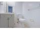 The bathroom features a modern vanity, toilet, mirror, and white walls at 1933 Wedgewood Dr, Stone Mountain, GA 30088