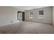 Spacious living room with carpet, natural light and an entryway visible in the background at 1933 Wedgewood Dr, Stone Mountain, GA 30088