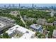Aerial view of neighborhood with lush landscaping and city skyline in the distance at 200 N Highland Ne Ave # 207, Atlanta, GA 30307