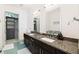 Bathroom featuring a dual vanity with granite countertops and modern fixtures at 200 N Highland Ne Ave # 207, Atlanta, GA 30307