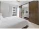 Bedroom with sliding barn doors that opens to the living room and access to the balcony at 200 N Highland Ne Ave # 207, Atlanta, GA 30307