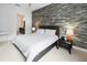 Comfortable bedroom featuring an accent wall, neutral tones, and natural light at 200 N Highland Ne Ave # 207, Atlanta, GA 30307