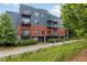Exterior of modern apartment building with a mix of brick and blue siding, with private balconies at 200 N Highland Ne Ave # 207, Atlanta, GA 30307