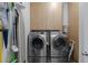 Convenient laundry room area featuring modern washer and dryer, as well as ample storage at 200 N Highland Ne Ave # 207, Atlanta, GA 30307