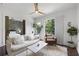 Cozy living room leading to a bedroom, showcasing a sliding barn door and ample natural light at 200 N Highland Ne Ave # 207, Atlanta, GA 30307