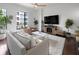 Bright living room boasts large windows, hardwood floors, modern decor, and balcony access at 200 N Highland Ne Ave # 207, Atlanta, GA 30307