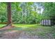 The property features a spacious backyard with mature trees and a storage shed at 545 Birch Ln, Lawrenceville, GA 30044