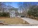 Quaint home boasting blue shutters and red door, complemented by a well-maintained front yard and driveway at 545 Birch Ln, Lawrenceville, GA 30044